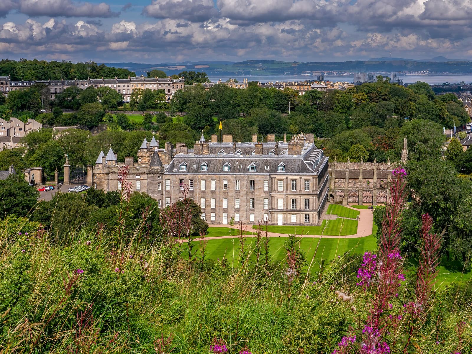 The Palace of Holyroodhouse and its gardens seen from Holyrood Park