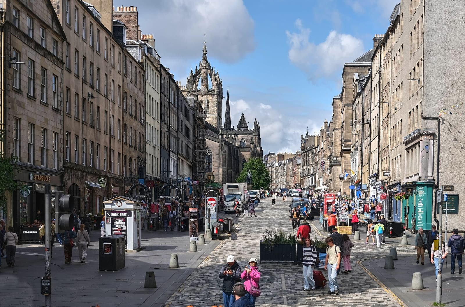 Pedestrians on the High Street section of the Royal Mile, with the crown spire of St Giles’ ahead