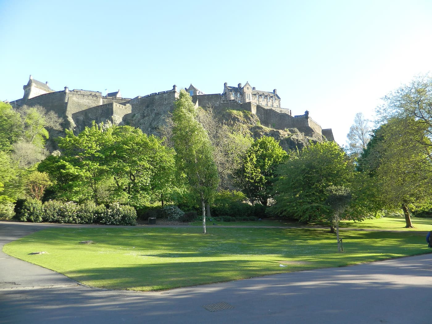 Edinburgh Castle on its rock above the trees and lawns of Princes Street Gardens